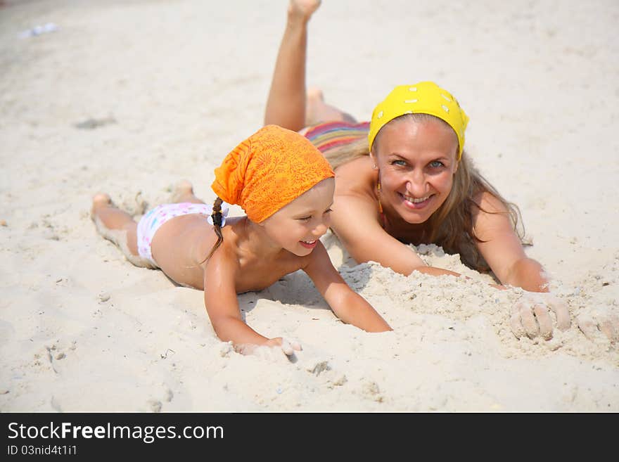 Little girl with her mother at the beach