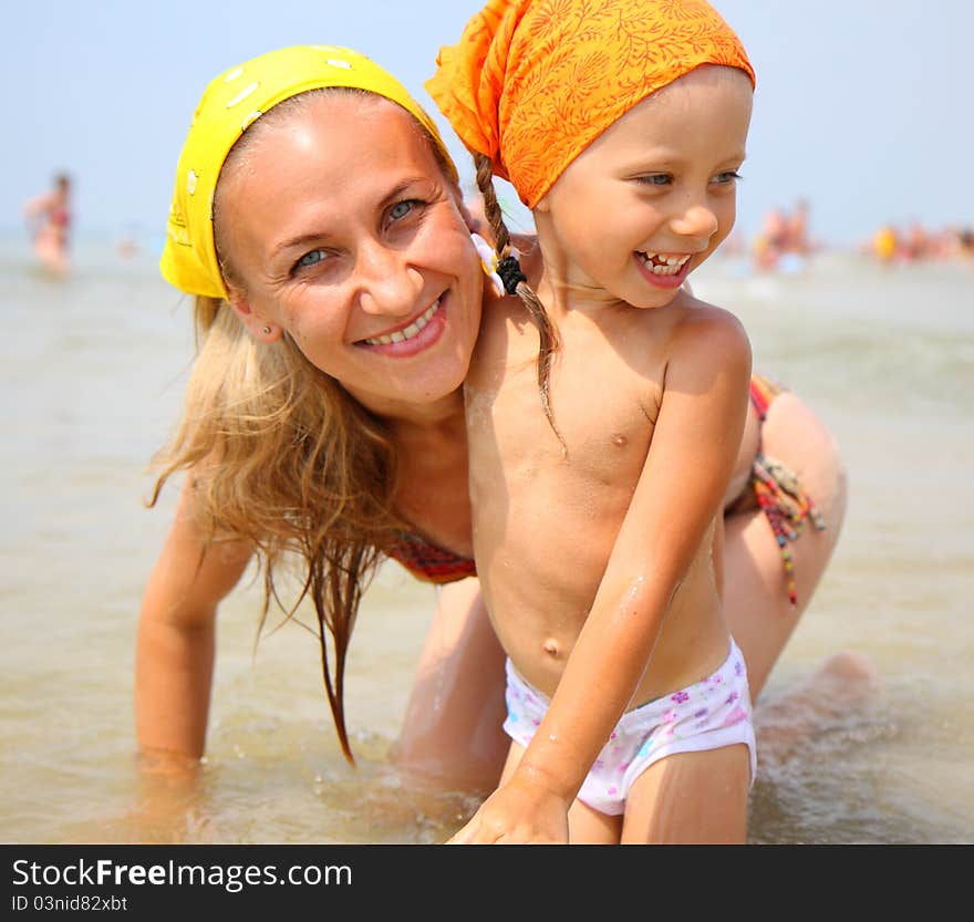 Little girl with her mother at the beach