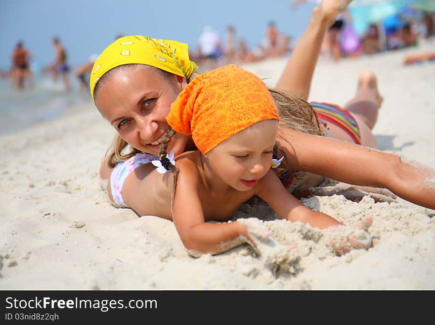 Little a girl with her mother at the beach