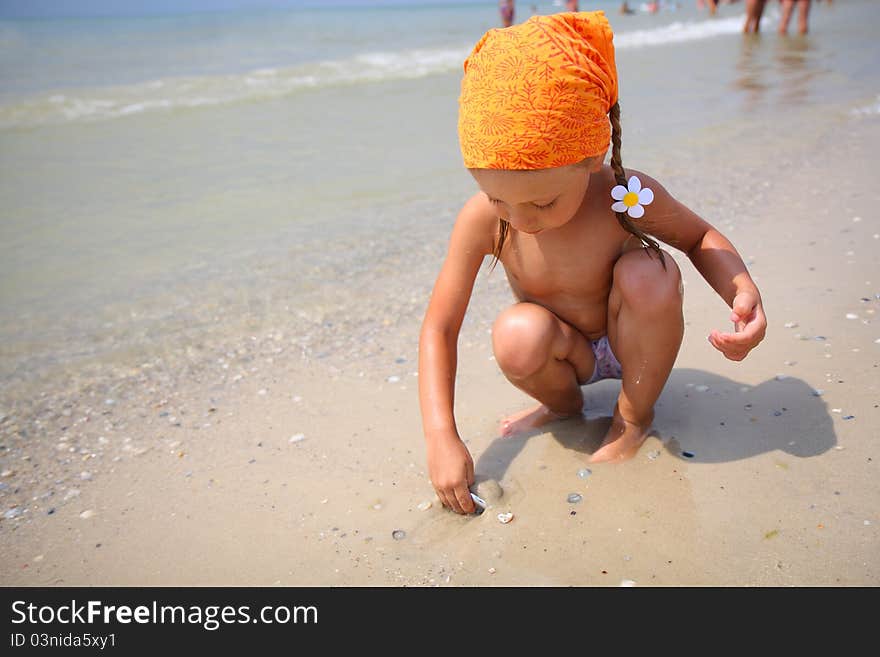 Cute baby girl playing with beach toys on tropical beach. Cute baby girl playing with beach toys on tropical beach