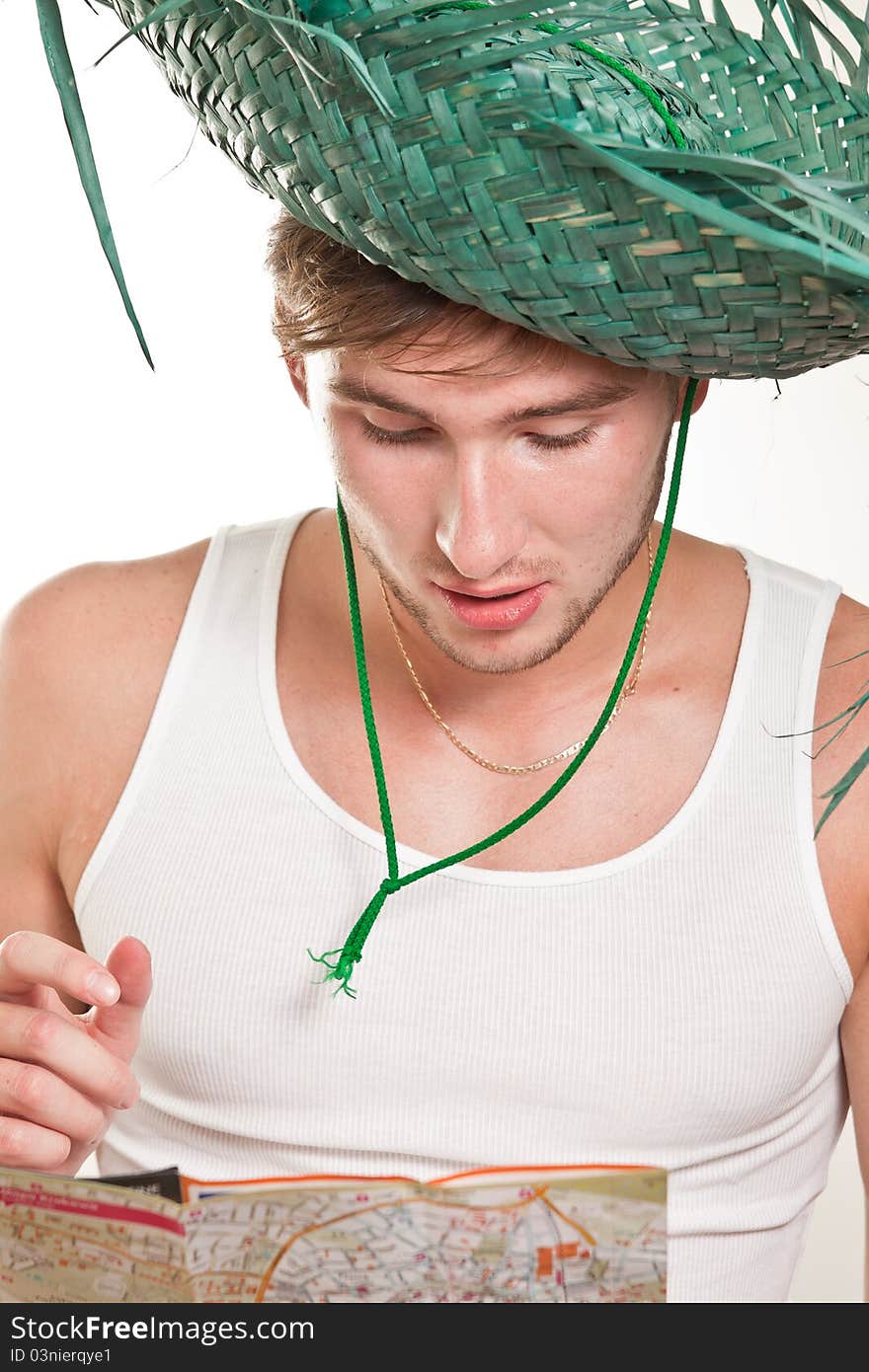 Tourist in straw hat looking at a map