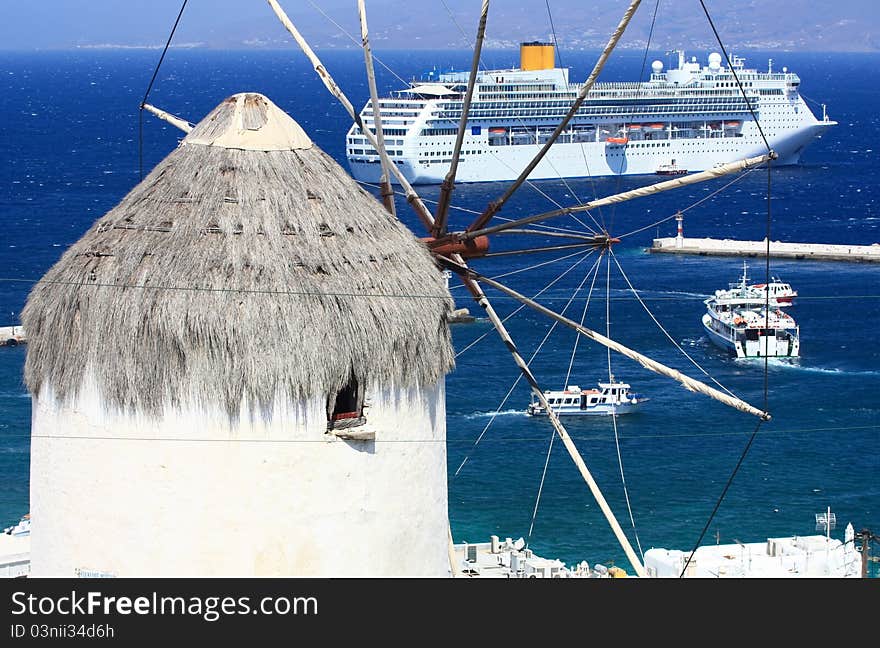 Huge cruise ship and a windmill in mykonos