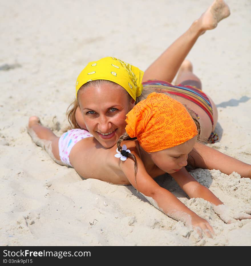 Little a girl with her mother at the beach