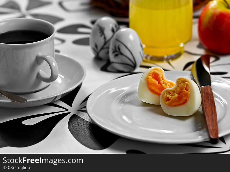 Breakfast with heart shaped egg, coffee, orange juice and an apple