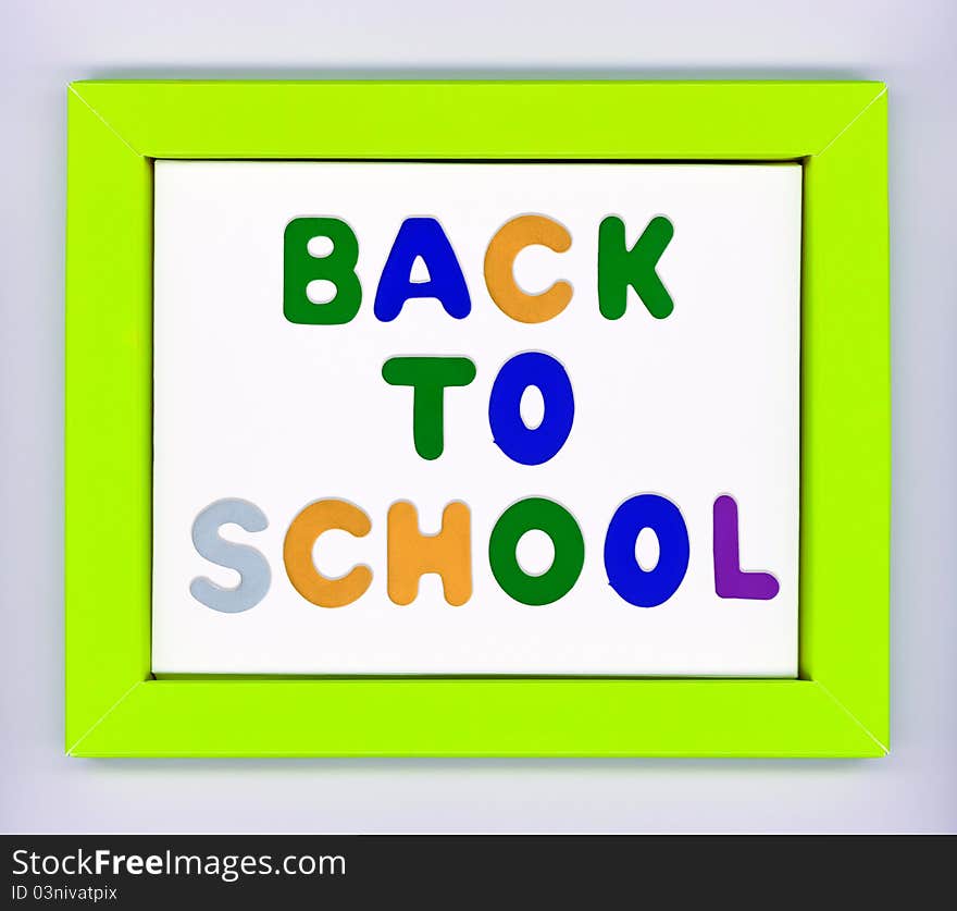 Green paper frame with words Back to school on white background