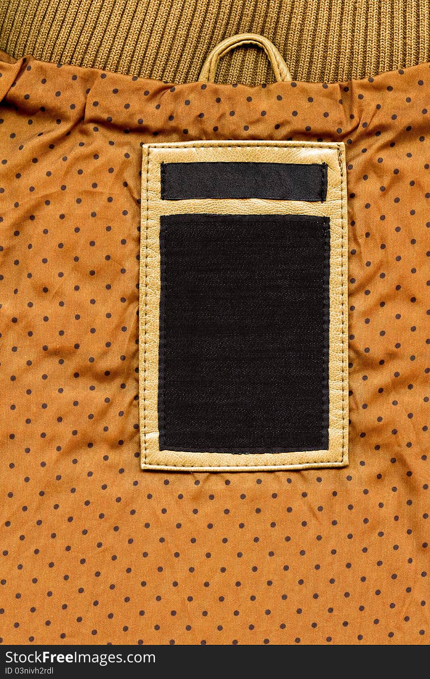 Jeans label on yellow dotted textile