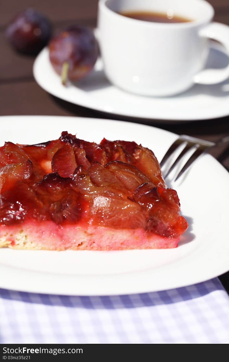 Freshly baked plum cake with coffee