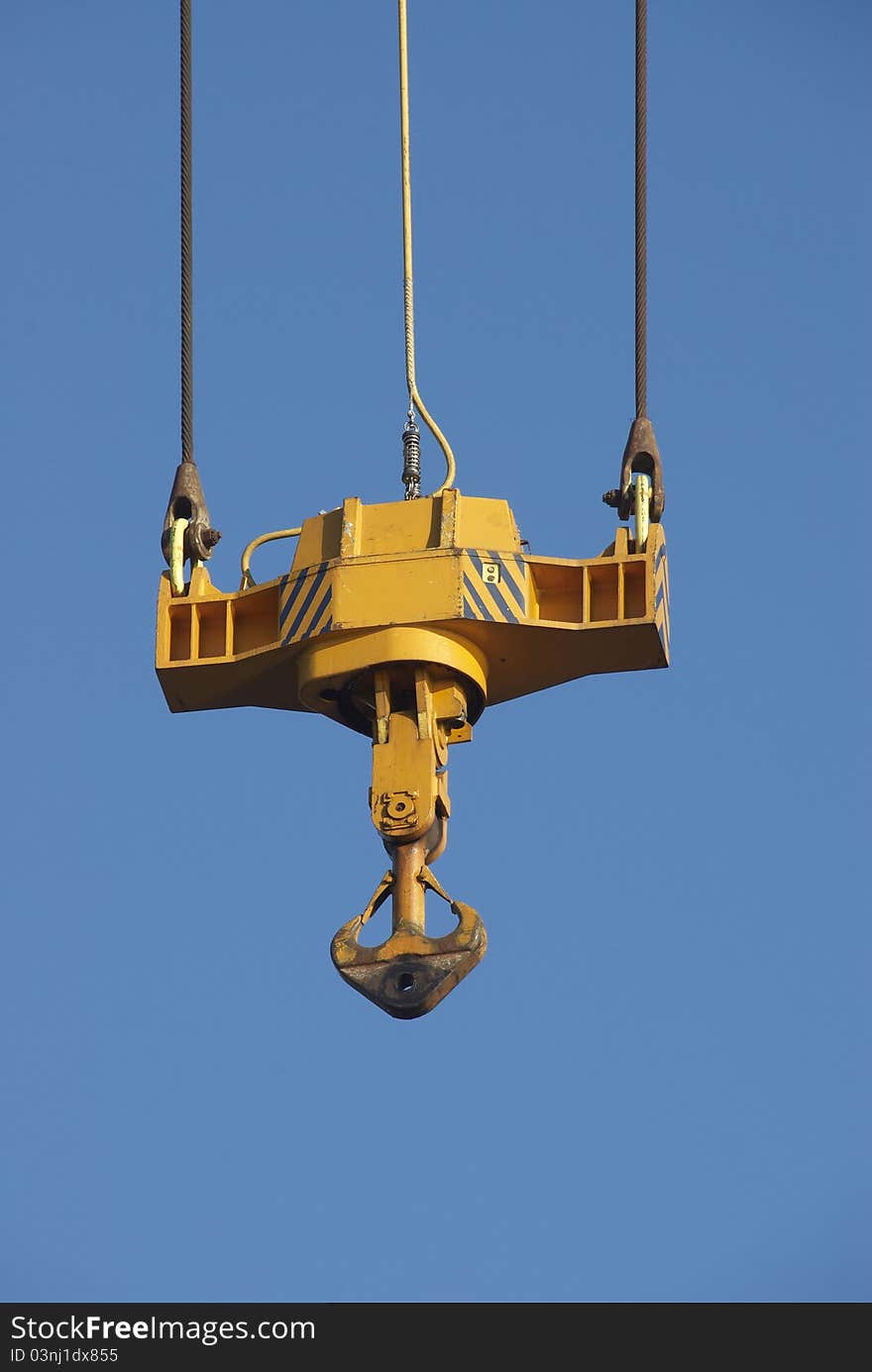 yellow crane hook into blue sky