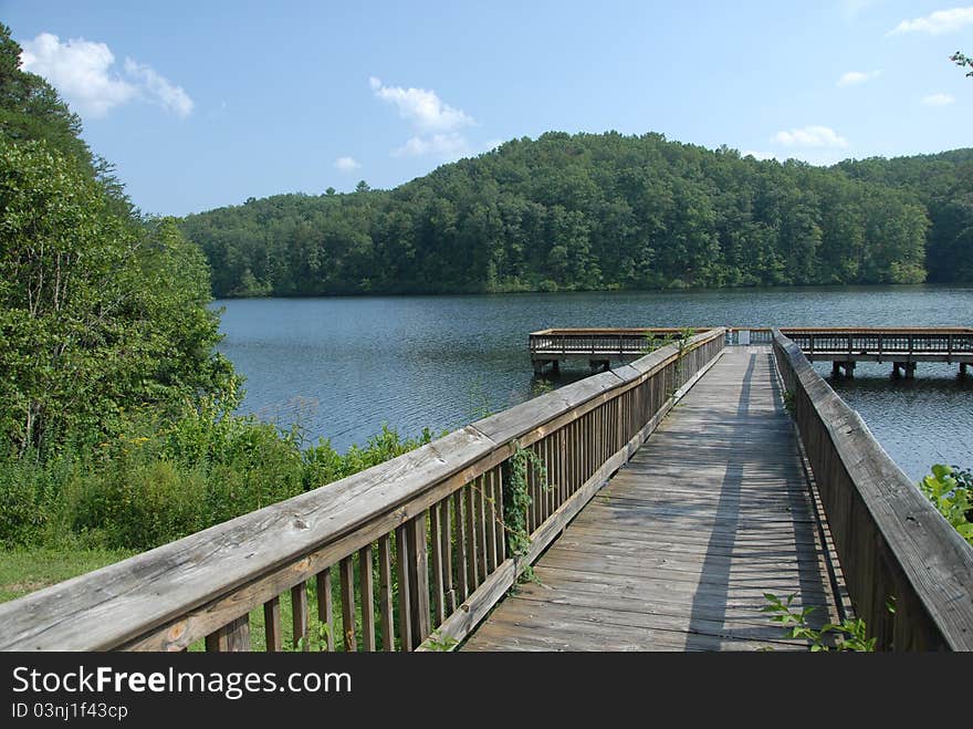 A view of a dock on a lake in the mountains during the summer. A view of a dock on a lake in the mountains during the summer