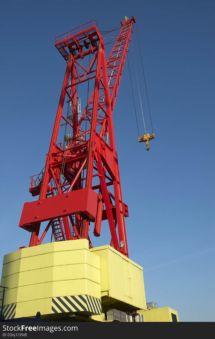 Red cranes in port with blue sky