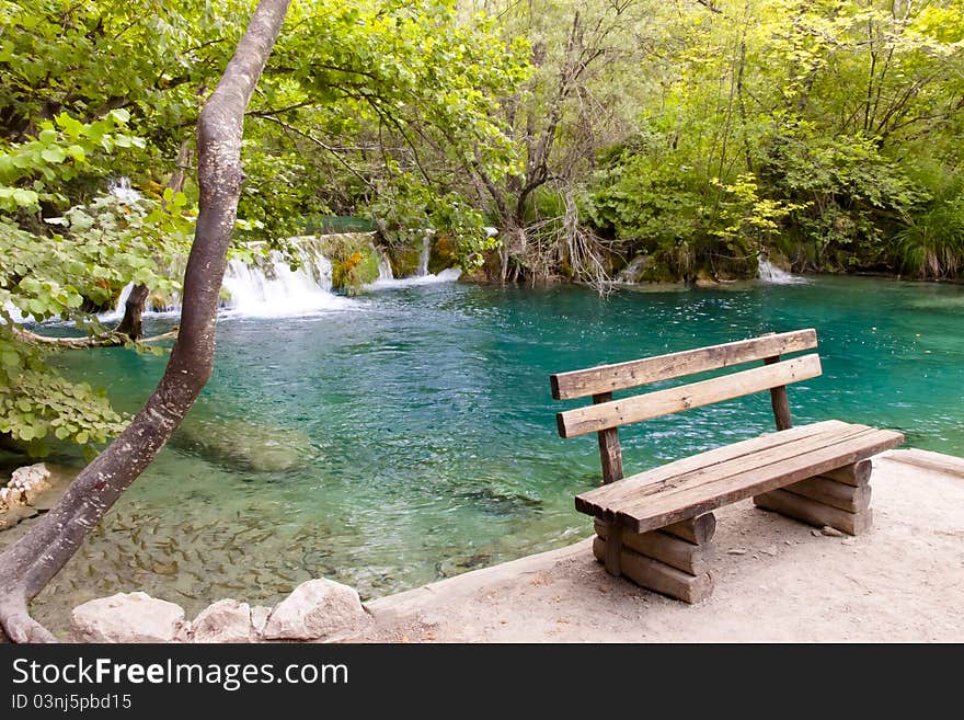 Small wooden bench in plitvice lake coratia.