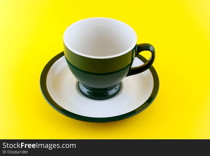 Empty Cup On Yellow Background.