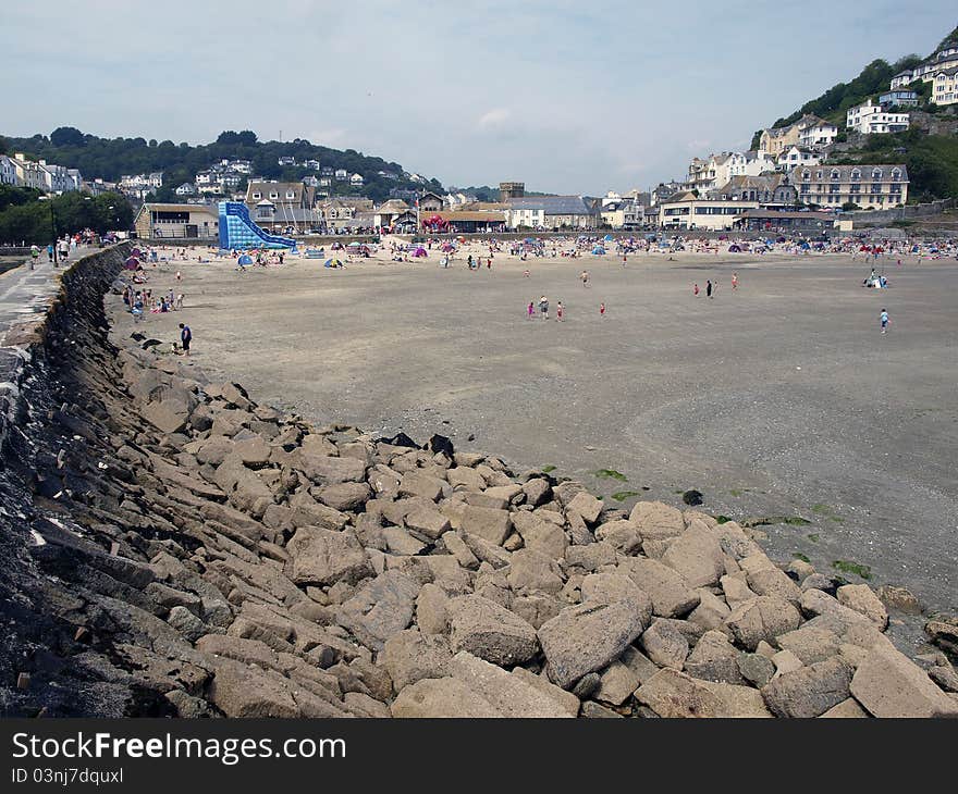 A meandering trail of beach rocks on a beach at Looe, England, the high textured large rocks and boulders are illuminated by a mid day sun. A meandering trail of beach rocks on a beach at Looe, England, the high textured large rocks and boulders are illuminated by a mid day sun.