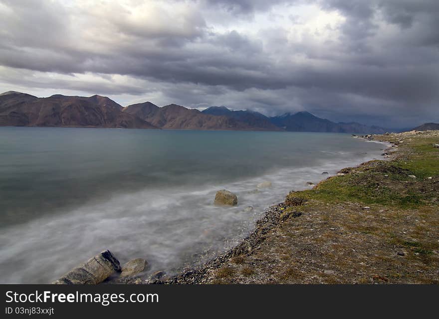 Pangong lake in evening with waves and clear green water, Ladakh, Jammu and Kashmir, India