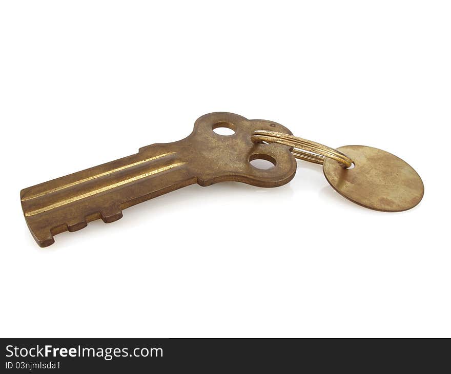 Big, fat replica key to a famous prison in solid brass on white. Big, fat replica key to a famous prison in solid brass on white