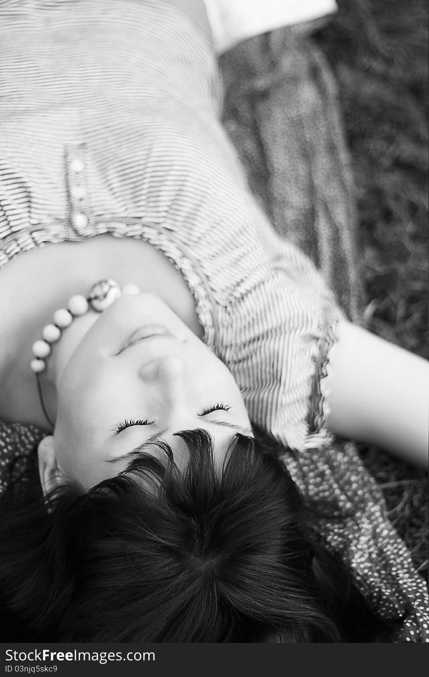 Attractive girl, lying on a grass peacefully