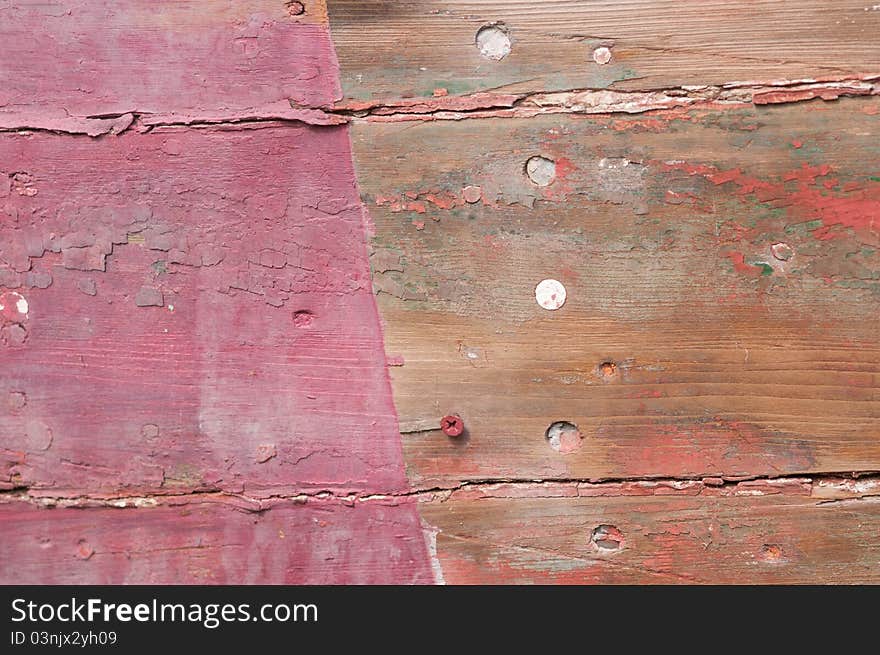 Cloesup of a shipwrecked wooden boat with faded red paint. Cloesup of a shipwrecked wooden boat with faded red paint.