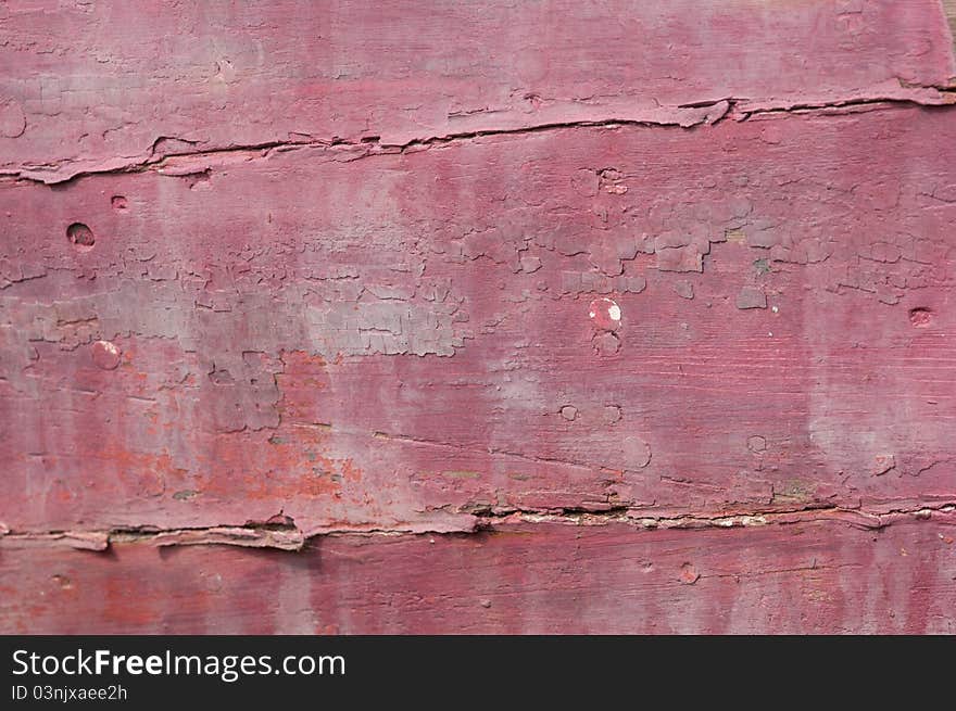 Cloesup of a shipwrecked wooden boat with faded red paint. Cloesup of a shipwrecked wooden boat with faded red paint.