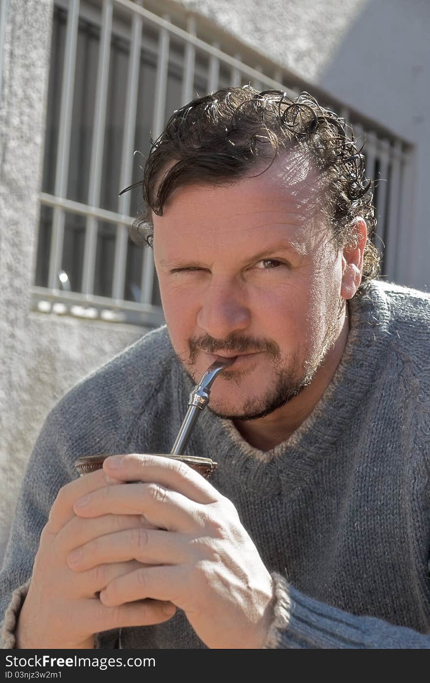 Uruguayan man enjoying his calabash hot-drink yerba-mate. Uruguayan man enjoying his calabash hot-drink yerba-mate