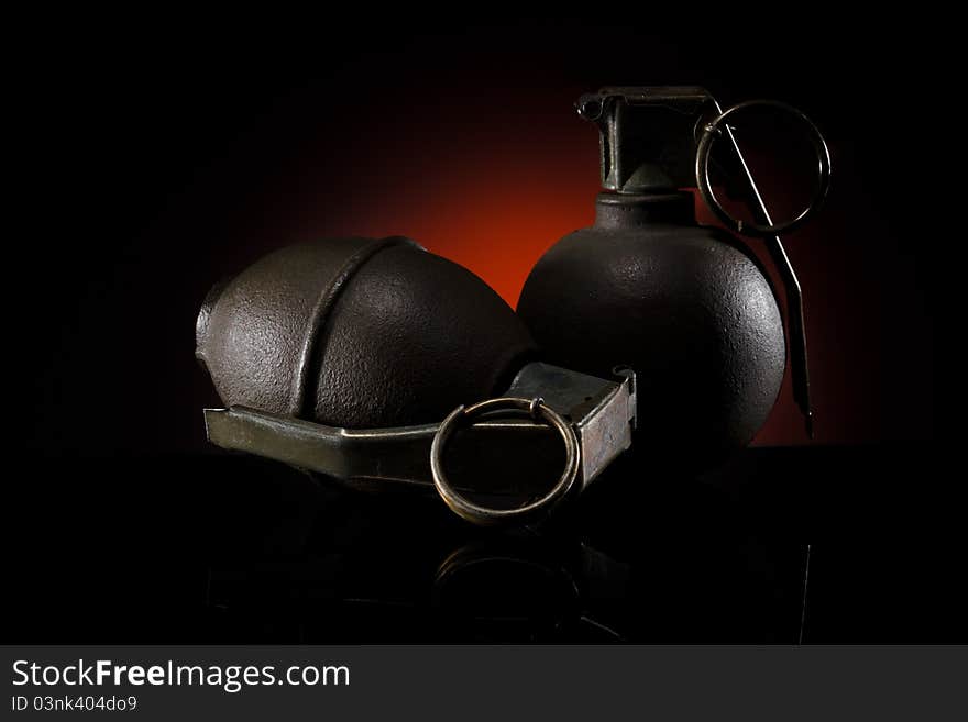 Two hand grenades on dark background