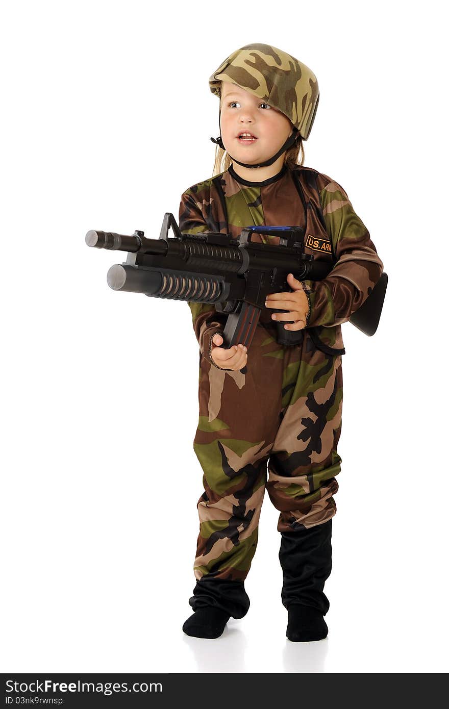 A pretty preschooler in soldier garb standing at the ready with a toy machine gun. Isolated. A pretty preschooler in soldier garb standing at the ready with a toy machine gun. Isolated.