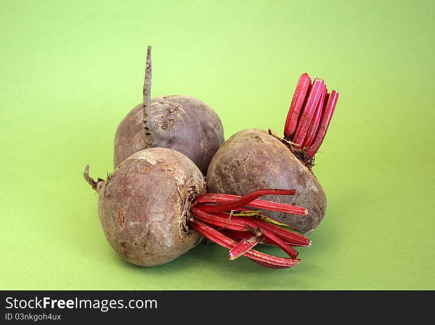 Raw beetroot over green background