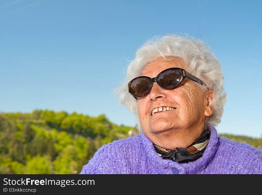 Smiling senior woman, picture taken during the sunny day.