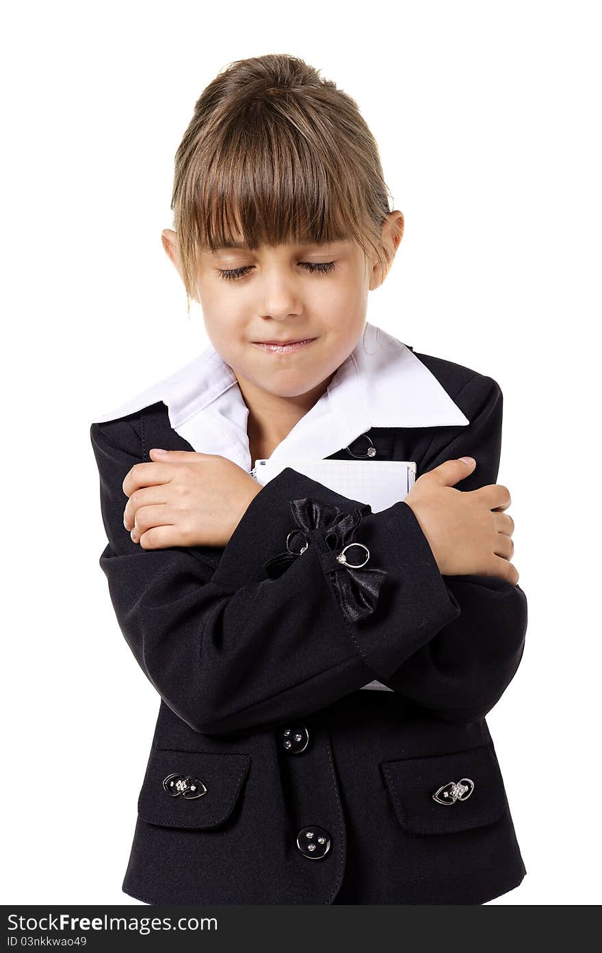 Little school girl in uniform with her notebook, isolated over white