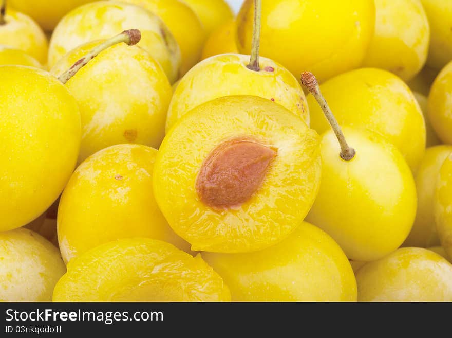 Studio-shot of small yellow plums also known as mellow mirabelles.