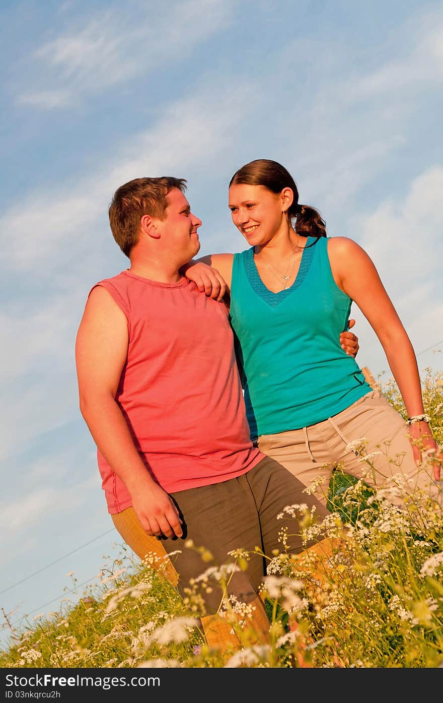 Young couple posing outdoor during the sunset.