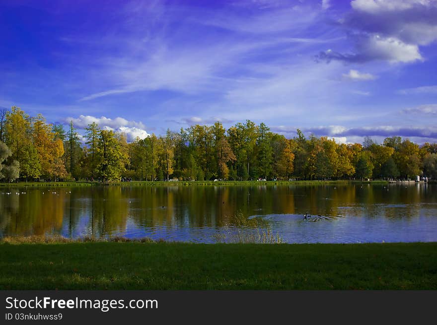 Reflection of colorful trees in water during autumn time. Reflection of colorful trees in water during autumn time