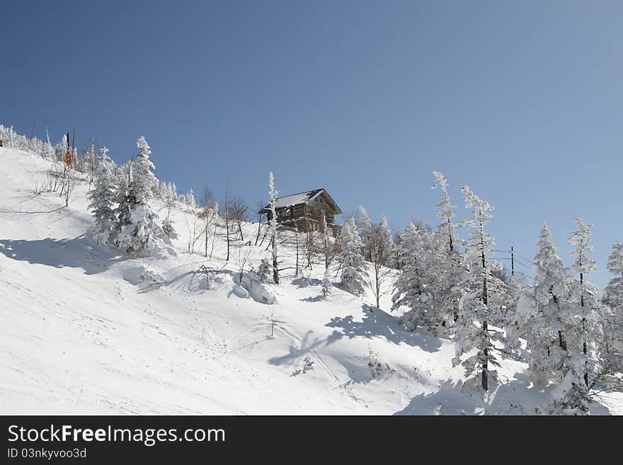 Wooden snow hut in snow mountain