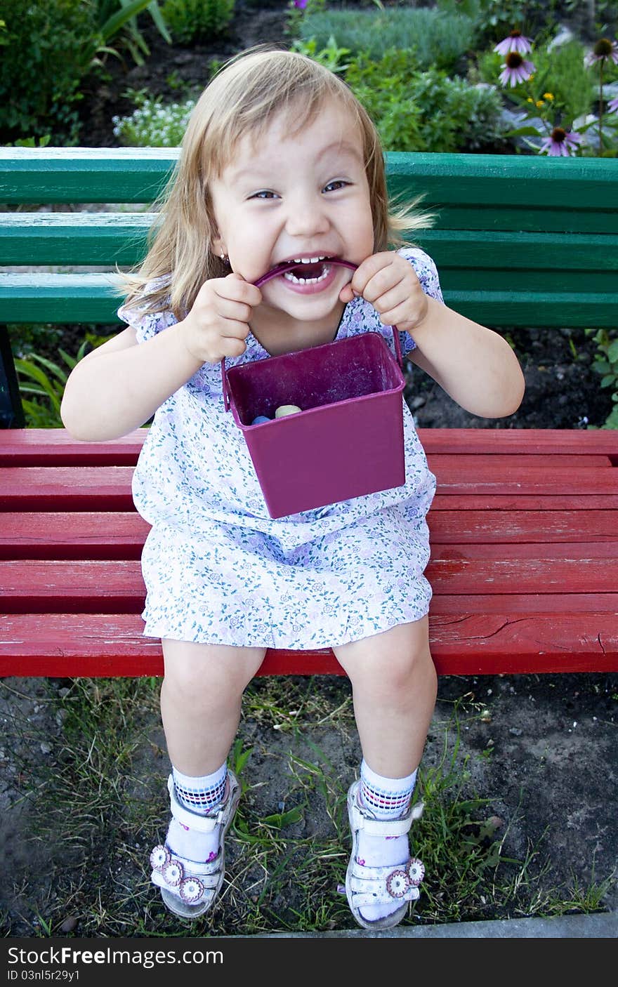 Portrait of blonde little girl outdoors