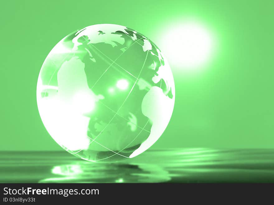 Glass globe with bright highlights on a green background. Glass globe with bright highlights on a green background