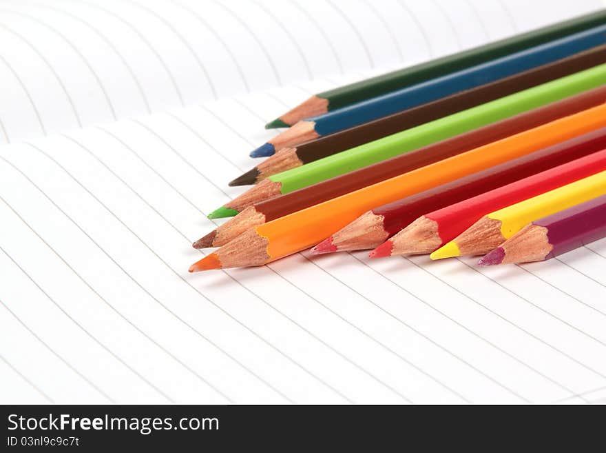 Pencil crayons on white writing paper