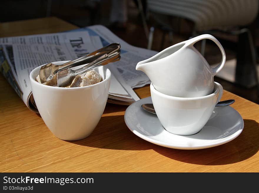 Businessman breakfast with a newspaper and a cup of coffee with cream. Businessman breakfast with a newspaper and a cup of coffee with cream