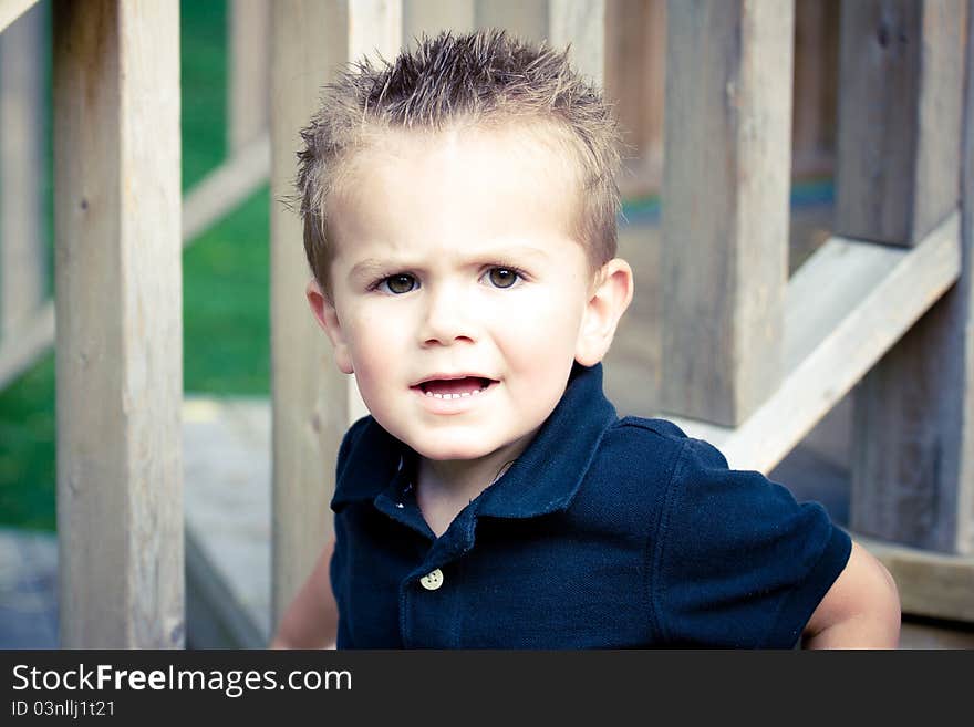 Cute Boy Sitting On Wood Stairs