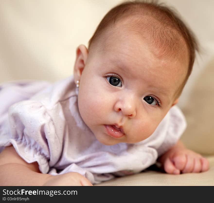 An eye level closeup of 3 month old girl. An eye level closeup of 3 month old girl