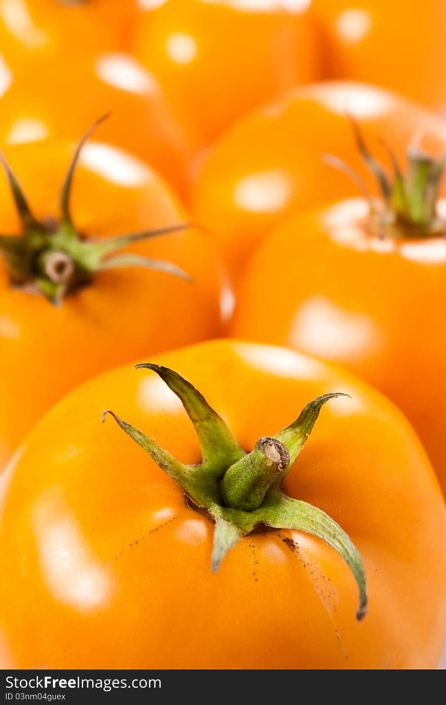 Bunch of shiny orange tomatoes