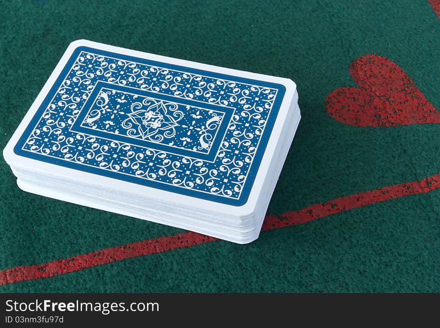 Deck of cards face down on a card table