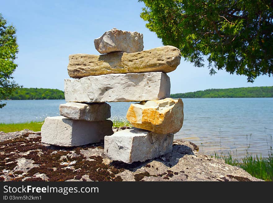 Inukshuk over looking a lake.