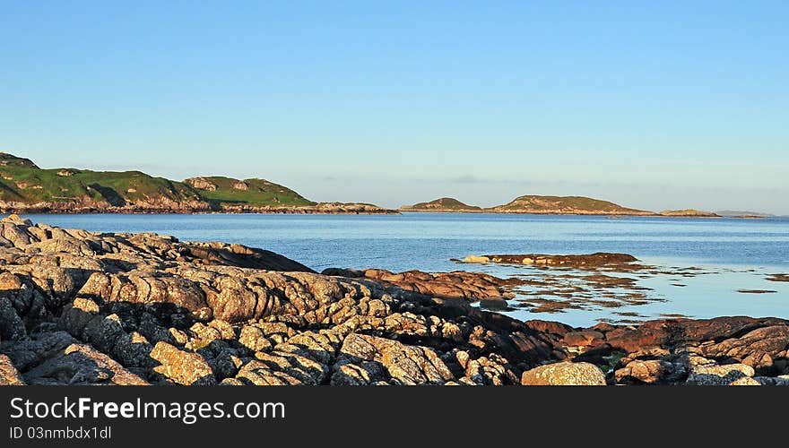 View of Island Erraid,Isle Mull,Argll and Bute Scotland, U.K. Erraid is a tidal island approximately 1-mile square located in the Inner Hebrides of Scotland. It lies west of Mull and southeast of Iona. The island receives about 1,000 millimetres of rain and 1,350 hours of sunshine annually, making it one of the driest and sunniest places on the western seaboard of Scotland.  It lies west of Mull &#x28;to which it is linked by a beach at low tide&#x29; and southeast of Iona. The island receives about 1,000 millimetres &#x28;40 in&#x29; of rain and 1,350 hours of sunshine annually, making it one of the driest and sunniest places on the western seaboard of Scotland. It is attended by numerous uninhabited small islets, the largest being Eilean Dubh &#x28;of which there are two&#x29;, Eilean nam Muc, Eilean Charmain, Eilean Ghomain and Eilean na Seamair. The island features a disused signal station for the lighthouses on Dubh Artach and Skerryvore and a row of cottages built for the lighthouse keepers. Satish Kumar has also visited the island and his autobiography includes an account of the event. The island is privately owned and is home to an intentional community, part of the Findhorn Foundation. There is a well-known anchorage on the western side of the island called &#x27;Tinker&#x27;s Hole&#x27;.  It is a deep but narrow channel between Erraid and the westernmost of the islets called Eilean Dubh. Erraid is one of the locations featured in the novel Kidnapped by Robert Louis. View of Island Erraid,Isle Mull,Argll and Bute Scotland, U.K. Erraid is a tidal island approximately 1-mile square located in the Inner Hebrides of Scotland. It lies west of Mull and southeast of Iona. The island receives about 1,000 millimetres of rain and 1,350 hours of sunshine annually, making it one of the driest and sunniest places on the western seaboard of Scotland.  It lies west of Mull &#x28;to which it is linked by a beach at low tide&#x29; and southeast of Iona. The island receives about 1,000 millimetres &#x28;40 in&#x29; of rain and 1,350 hours of sunshine annually, making it one of the driest and sunniest places on the western seaboard of Scotland. It is attended by numerous uninhabited small islets, the largest being Eilean Dubh &#x28;of which there are two&#x29;, Eilean nam Muc, Eilean Charmain, Eilean Ghomain and Eilean na Seamair. The island features a disused signal station for the lighthouses on Dubh Artach and Skerryvore and a row of cottages built for the lighthouse keepers. Satish Kumar has also visited the island and his autobiography includes an account of the event. The island is privately owned and is home to an intentional community, part of the Findhorn Foundation. There is a well-known anchorage on the western side of the island called &#x27;Tinker&#x27;s Hole&#x27;.  It is a deep but narrow channel between Erraid and the westernmost of the islets called Eilean Dubh. Erraid is one of the locations featured in the novel Kidnapped by Robert Louis