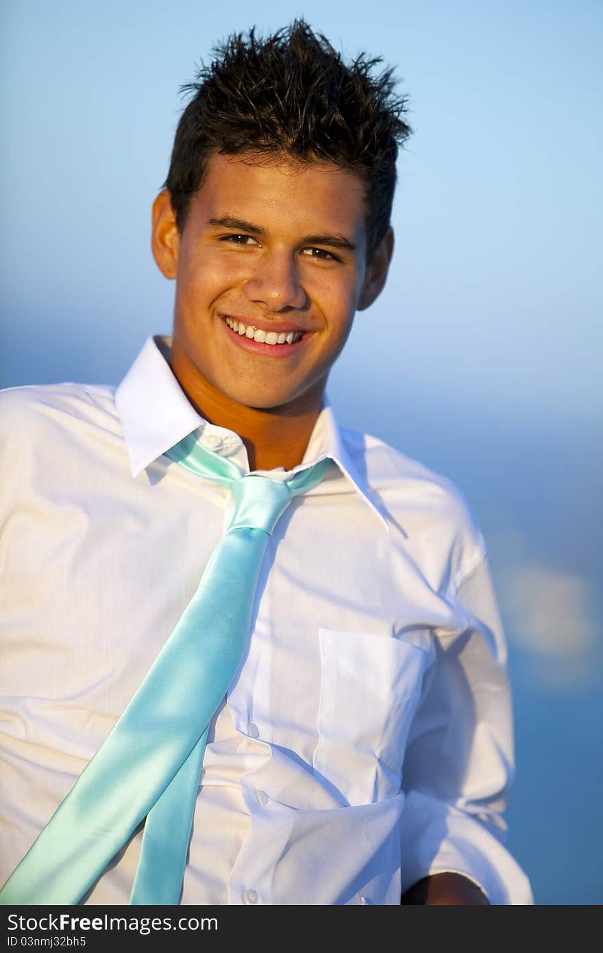 Young man on a pier in a tie at sunset. Young man on a pier in a tie at sunset