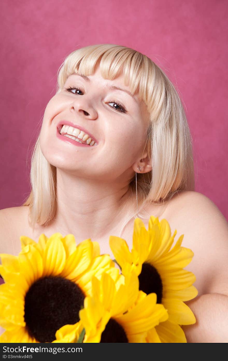 Portrait of the beautiful girl with flowers