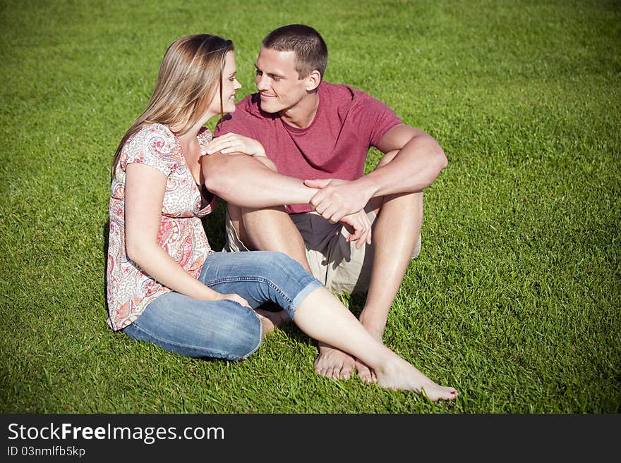 Loving couple sitting in the grass