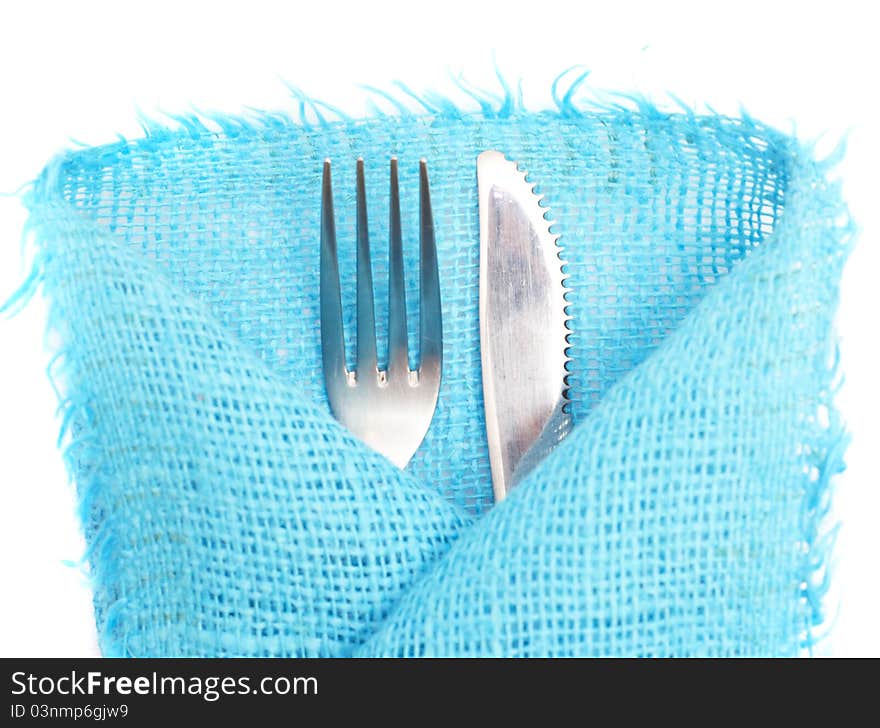 Knife, fork and a napkin on a white background