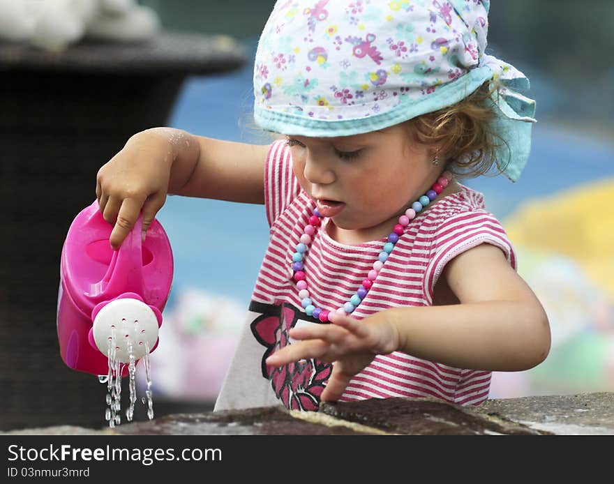 Little cute baby is gardening