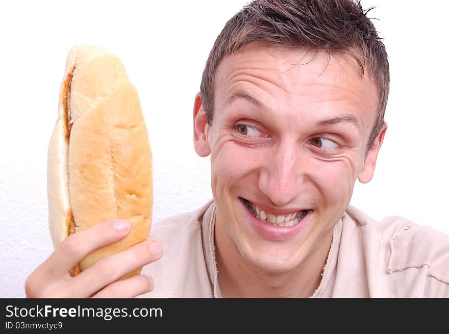 Portrait of a young man looking at his sandwich. Portrait of a young man looking at his sandwich