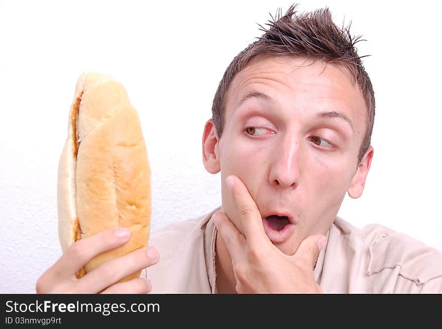 Portrait of a young man looking at his sandwich