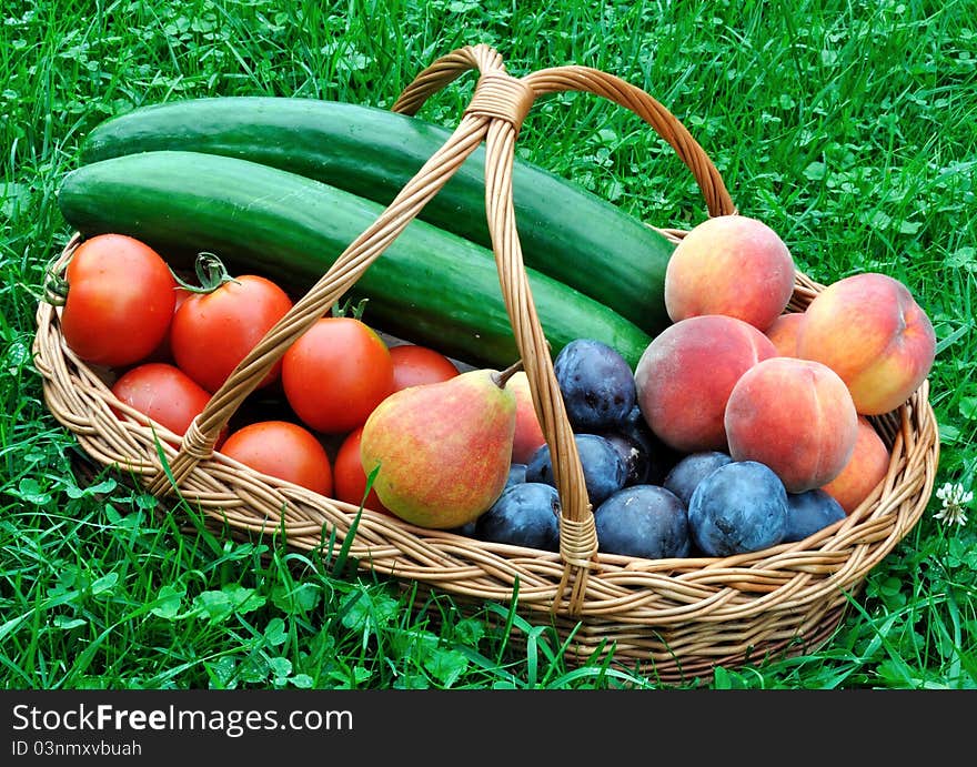 Colorful fresh group of fruits and vegetables in basket on grass. Colorful fresh group of fruits and vegetables in basket on grass